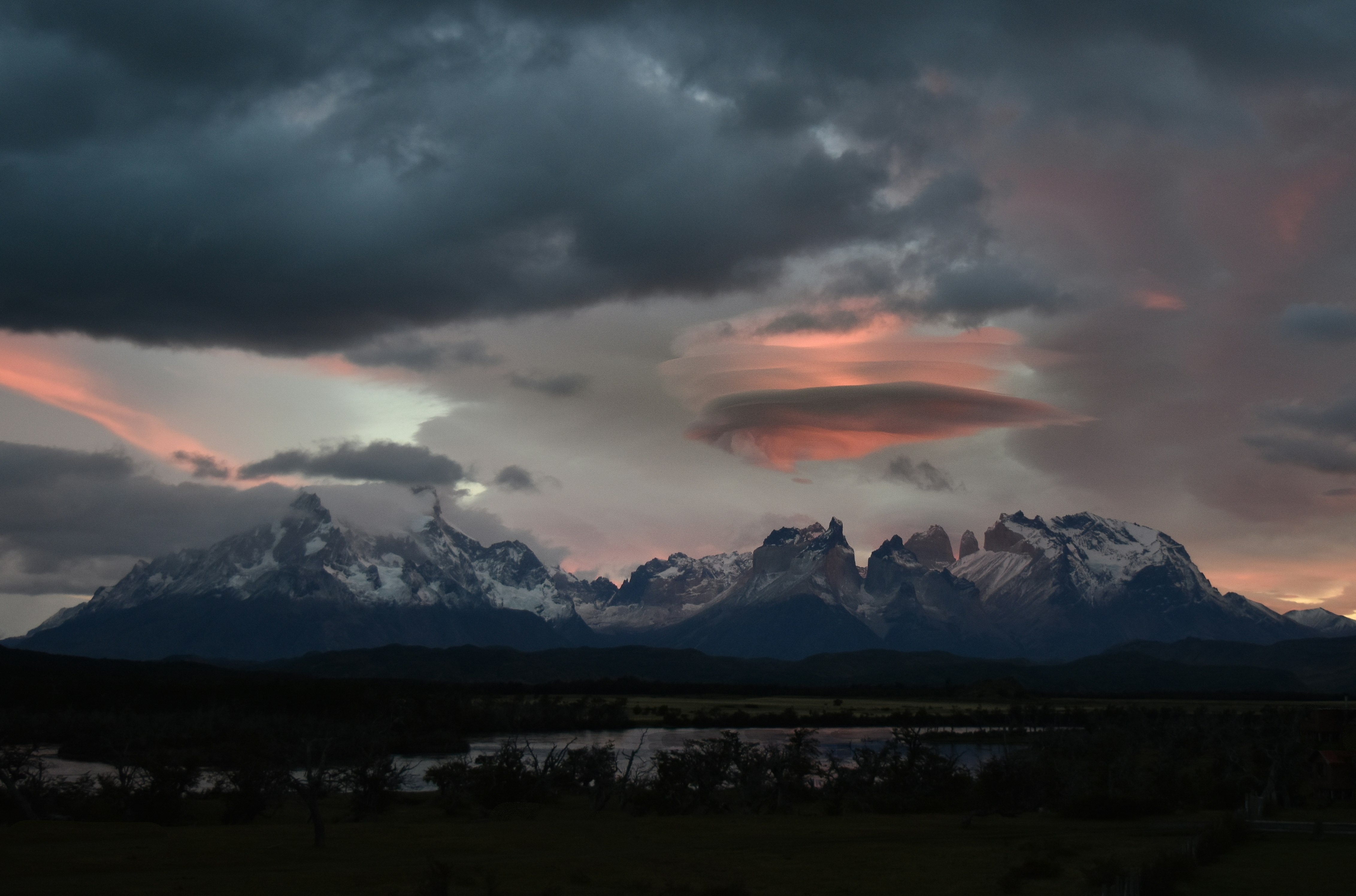 silhouette of mountains under cloudy sky during daytime